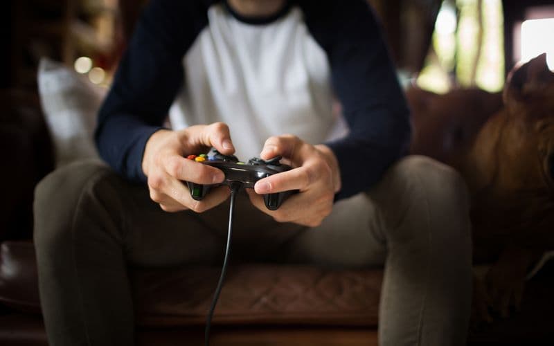 guy playing video game on couch